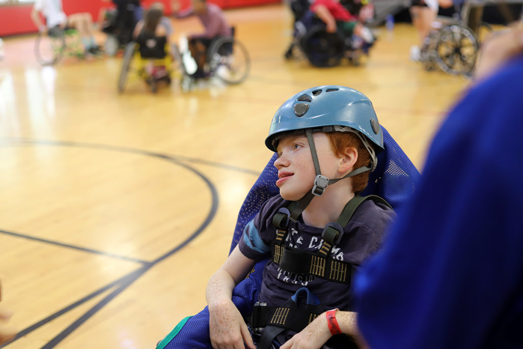A boy in the gym sits in his chair