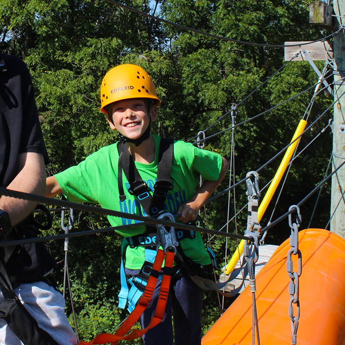 A boy on the high ropes course.